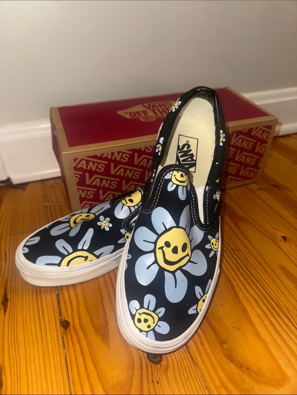 Vans Black Slip-On Sneakers with Yellow & Light Blue Daisy Smiley Print